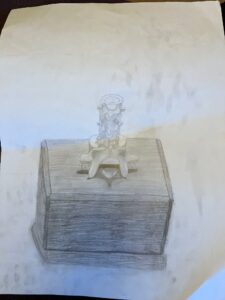 Pencil drawing on white paper of a yoga block with two spine squishies balanced on top of each other on top of the yoga block.