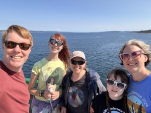 Carl, Amy, Melissa, Sarah, and Jenny on the ferry with water in the background 