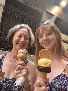 Jenny and Amy with full gelato cones, smiling before they eat them and before the sea gull stole Amy's remaining bit of cone.